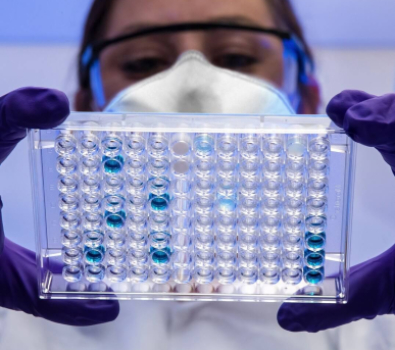 Blog Main Image - Researcher Woman Examining Samples Blue